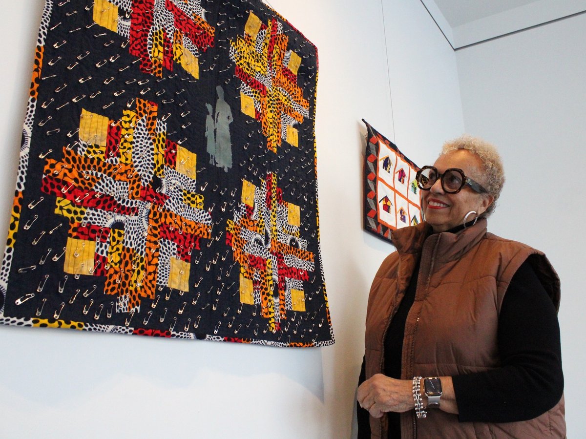 Johyné Geran looks at one of her pieces ahead of the reception for the Black History Month art exhibit at Gallery 1075 in West Sacramento.