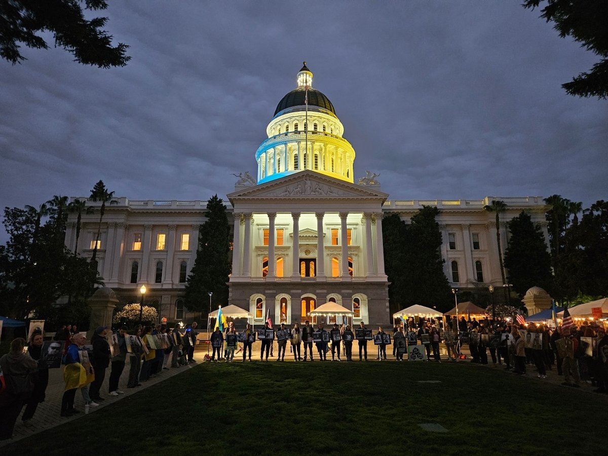 The California State Capitol lights up with the colors of the Ukrainian flag Feb. 24, 2026. Attendees carries photographs of Ukrainian civilians and soldiers killed in the fighting.