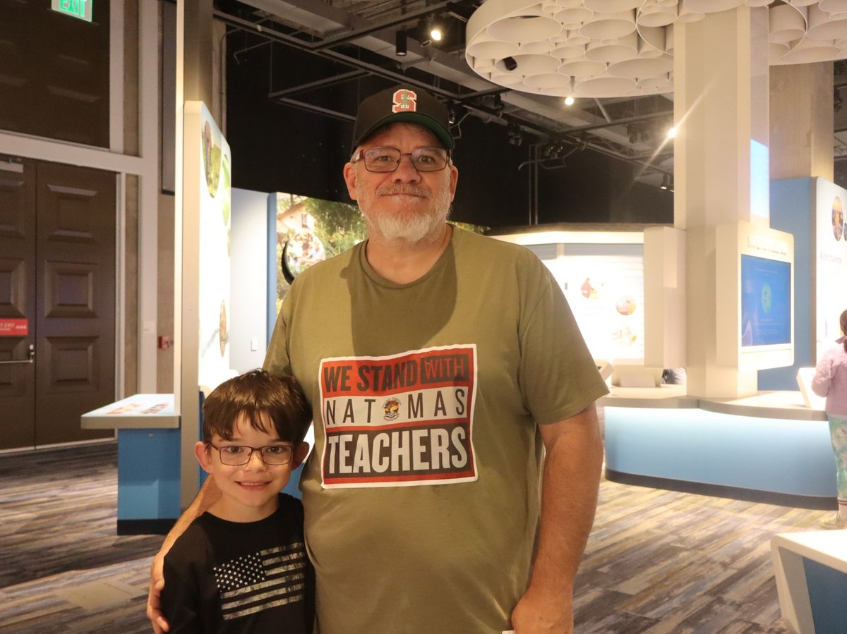 Troy Sutton with one of his three kids at the SMUD Science Museum of Curiosity Thursday March 12, 2026. Sutton is utilizing free admission for kids and discounted prices for adults while teachers in the Natomas Unified School District are on strike.