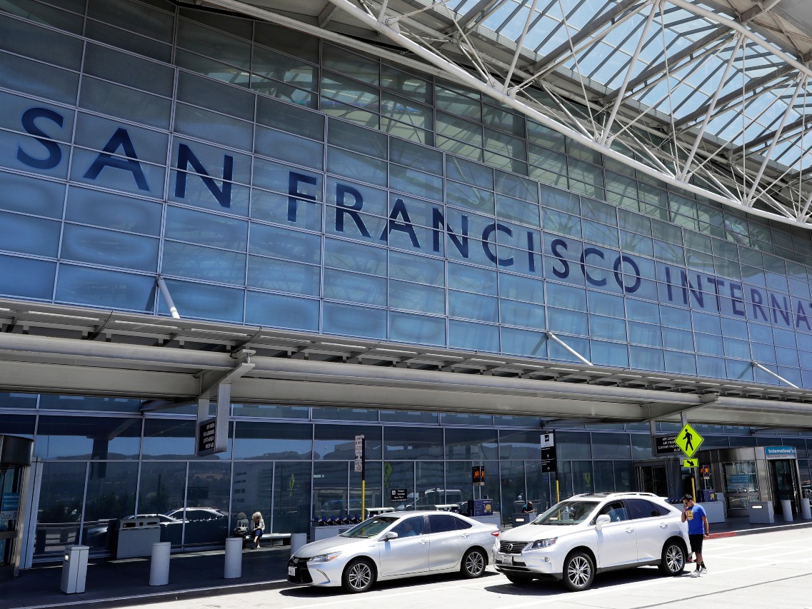 FILE - Vehicles wait outside the international terminal at San Francisco International Airport, in San Francisco, July 11, 2017.