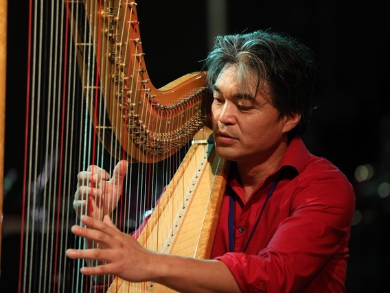 Motoshi Kosako playing the harp.