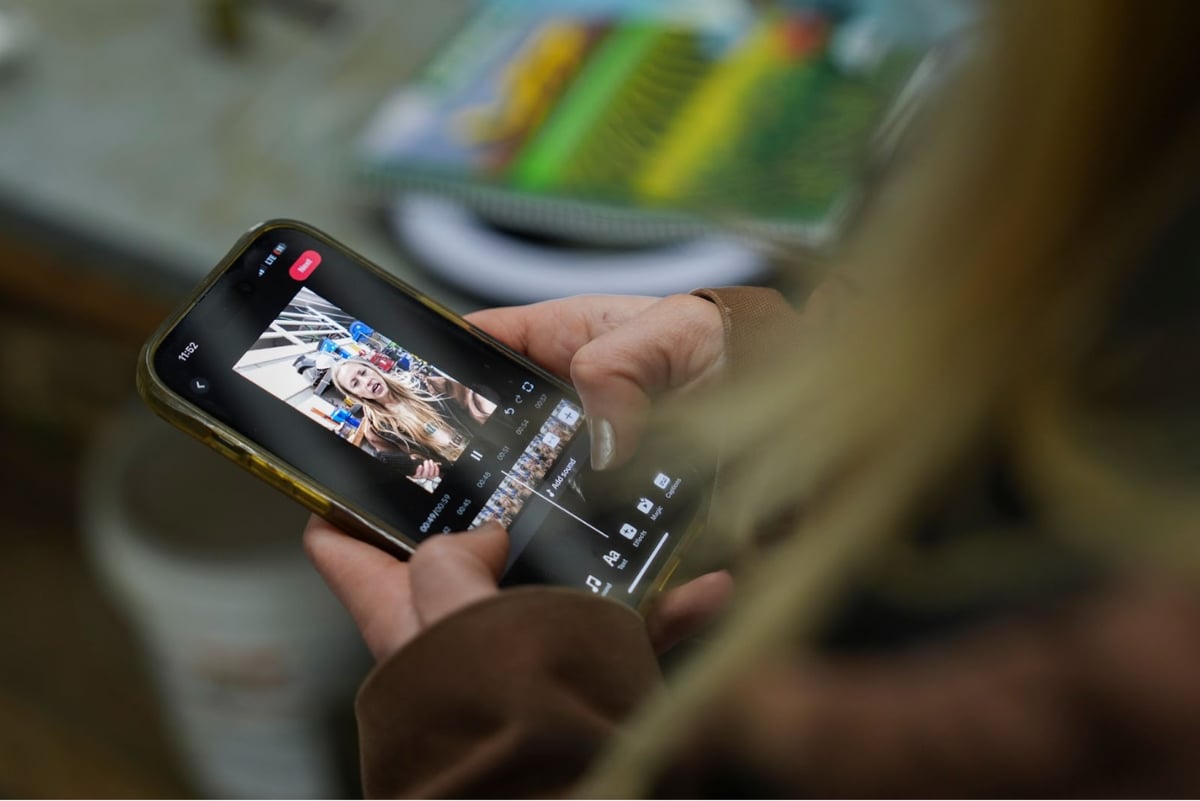 A social media influencer edits a video on the TikTok app.