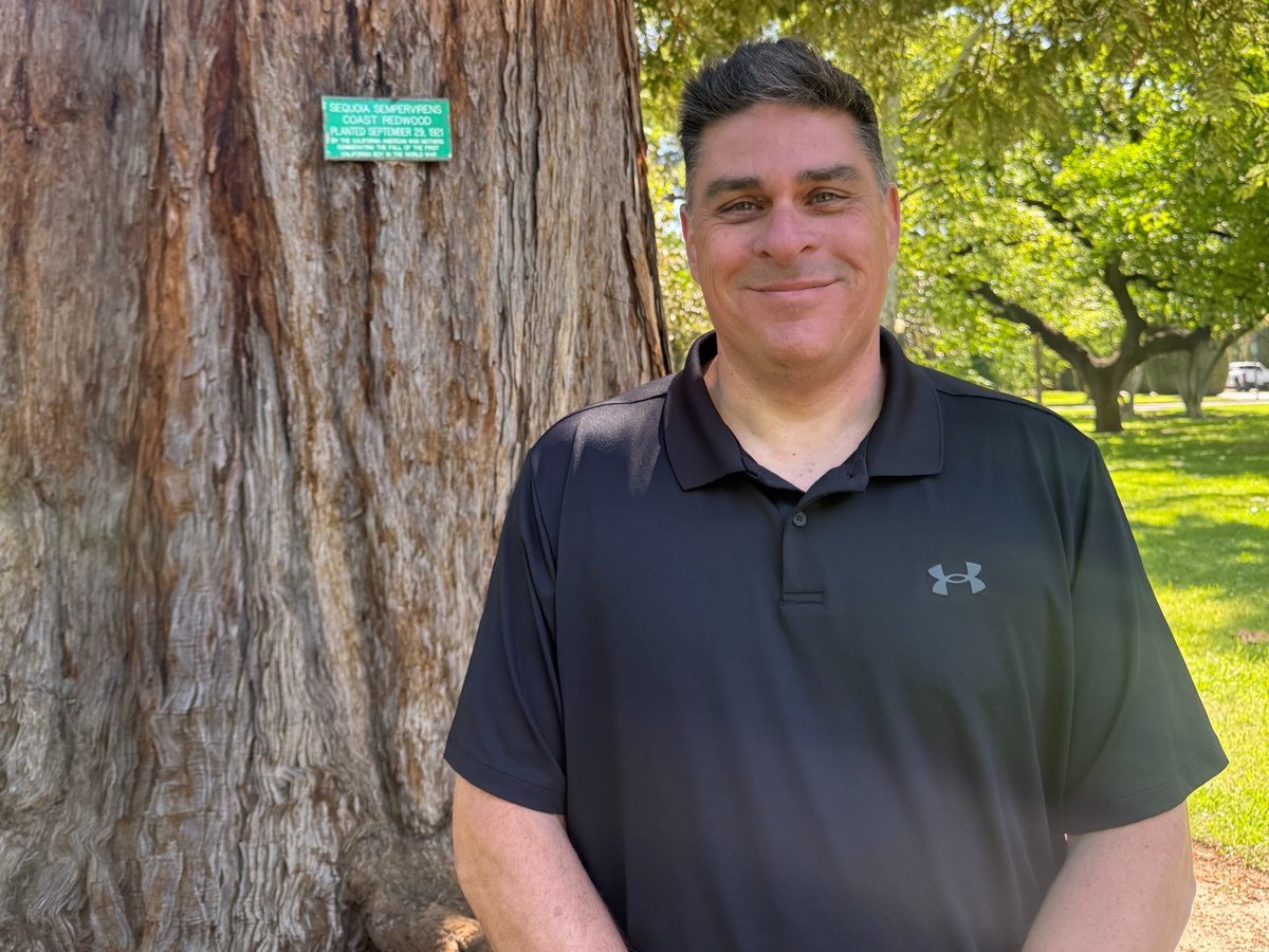 Michael Nielson is the grounds operation manager for the Department of General Services. He's stands next to his favorite tree on Thursday April 16, 2026.