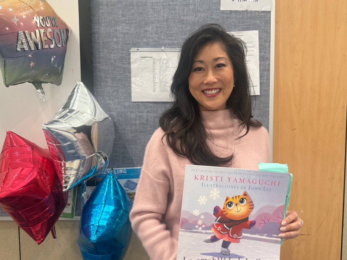 Former figure skater and Olympic gold medalist Kristi Yamaguchi hold a Spanish copy of her book "Cara's Kindness" at Hazel Strauch Elementary School Monday May 4, 2026.