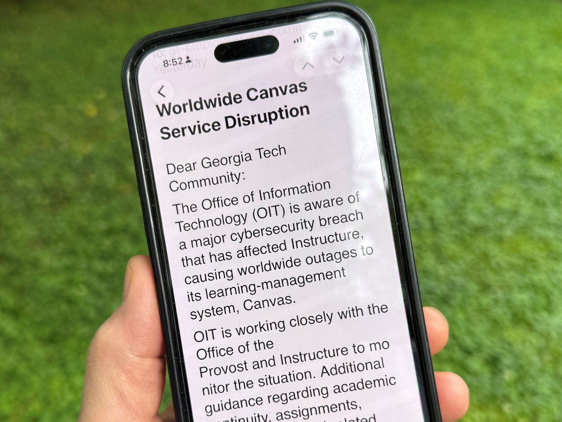An image of a notice sent by Georgia Tech's information technology department warning students, professors and staff about the cybersecurity breach of the Canvas system it uses for assignments and grading is displayed on a phone, Friday, May 8, 2026.