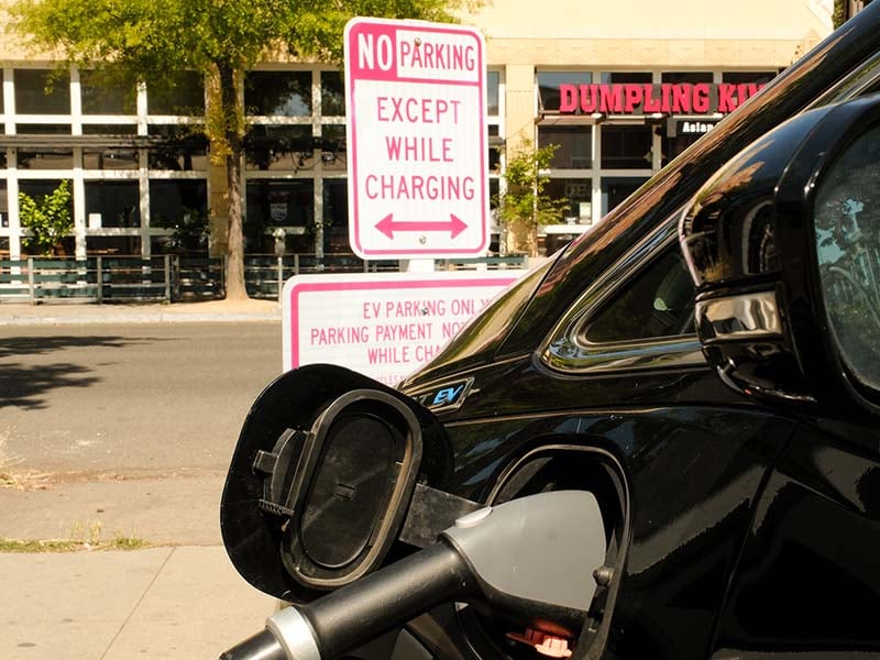 A Chevrolet Bolt EV charges at an Electrify America charger on the corner of L and 16th Street on May 19, 2026.