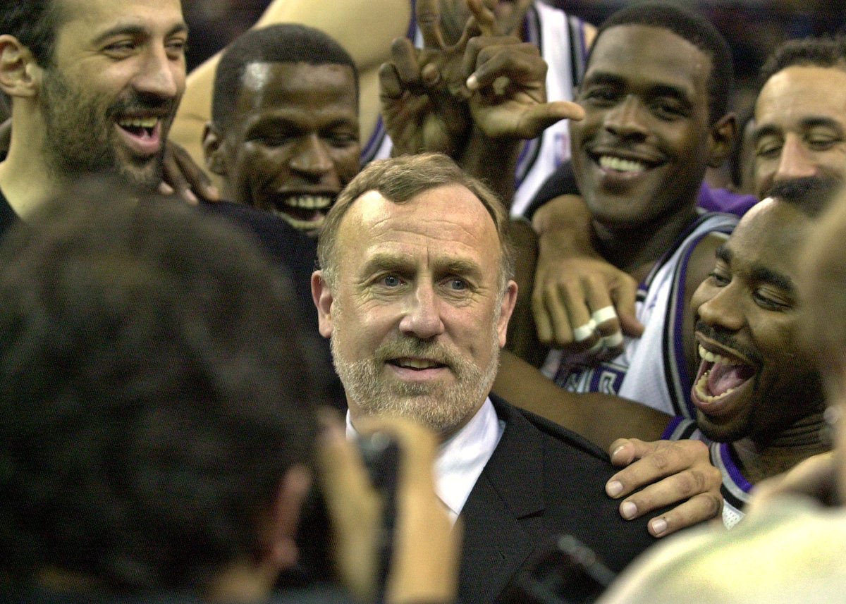 Sacramento Kings coach Rick Adelman, center, is mobbed by his players at Arco Arena in Sacramento, Calif., after the Kings defeated the Orlando Magic 112 -100, marking Adelman's 500th career coaching victory, Tuesday, Dec. 11, 2001.