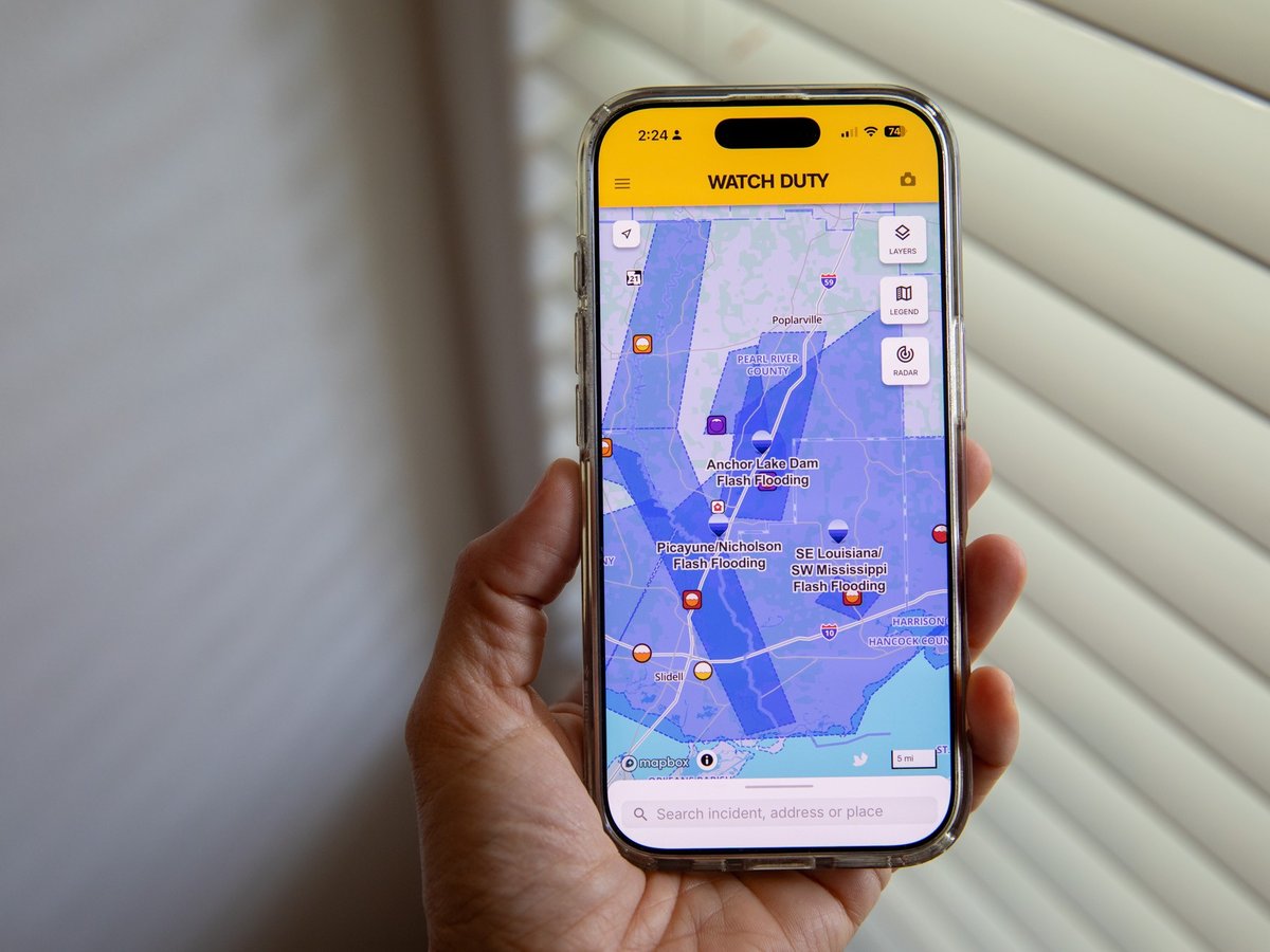 A person uses the Watch Duty app to track floods, Thursday, June 18, 2026, in San Diego, Calif.