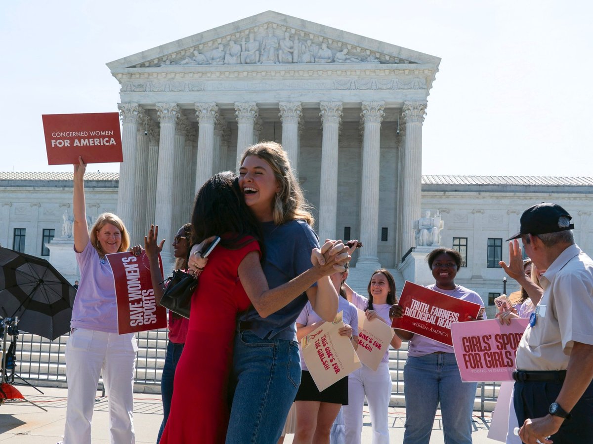Activist Macy Charles, center right, hugging Penny Nance, as they celebrate the transgender athletes ruling outside of the Supreme Court on Capitol Hill, Tuesday, June 30, 2026, in Washington.