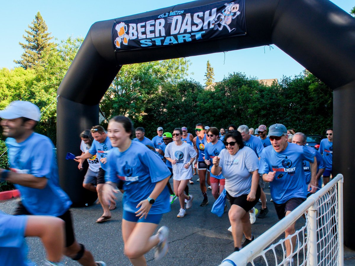 Runners in the Beer Dash at Super Owl Brewing in Davis rush to the finish line on July 8, 2026.