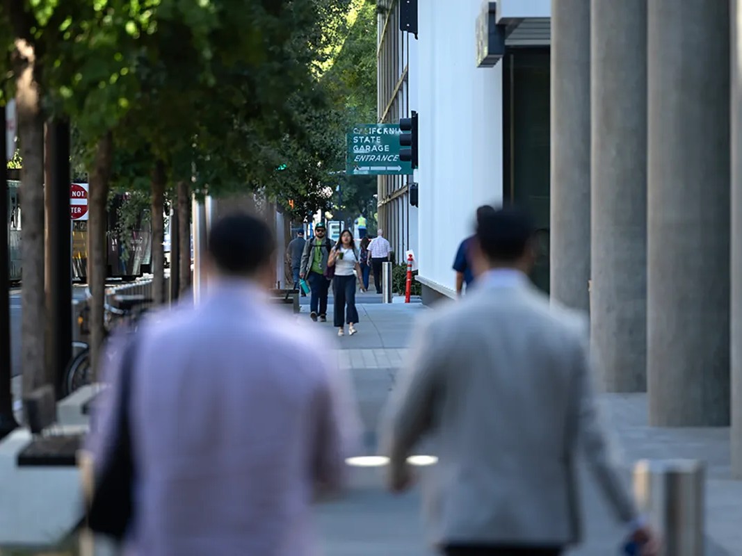State workers and city residents walk through downtown Sacramento on the morning of July 15, 2026.