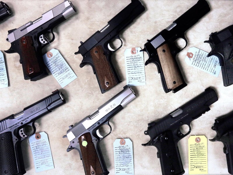 Semi-automatic handguns are on display for purchase at Capitol City Arms Supply Wednesday, July 10, 2013, in Springfield, Ill.