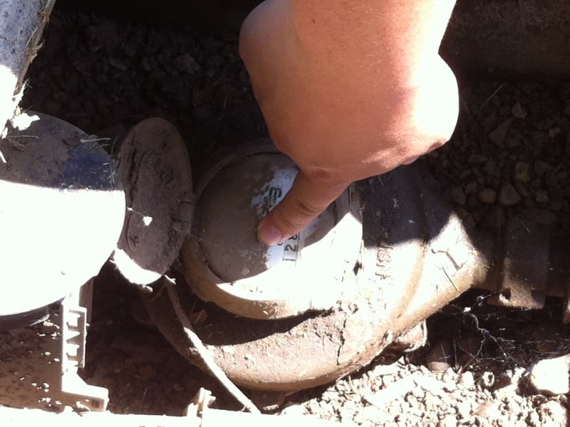 A Sacramento City employee looks for evidence of water waste at a residence by inspecting the water meter.