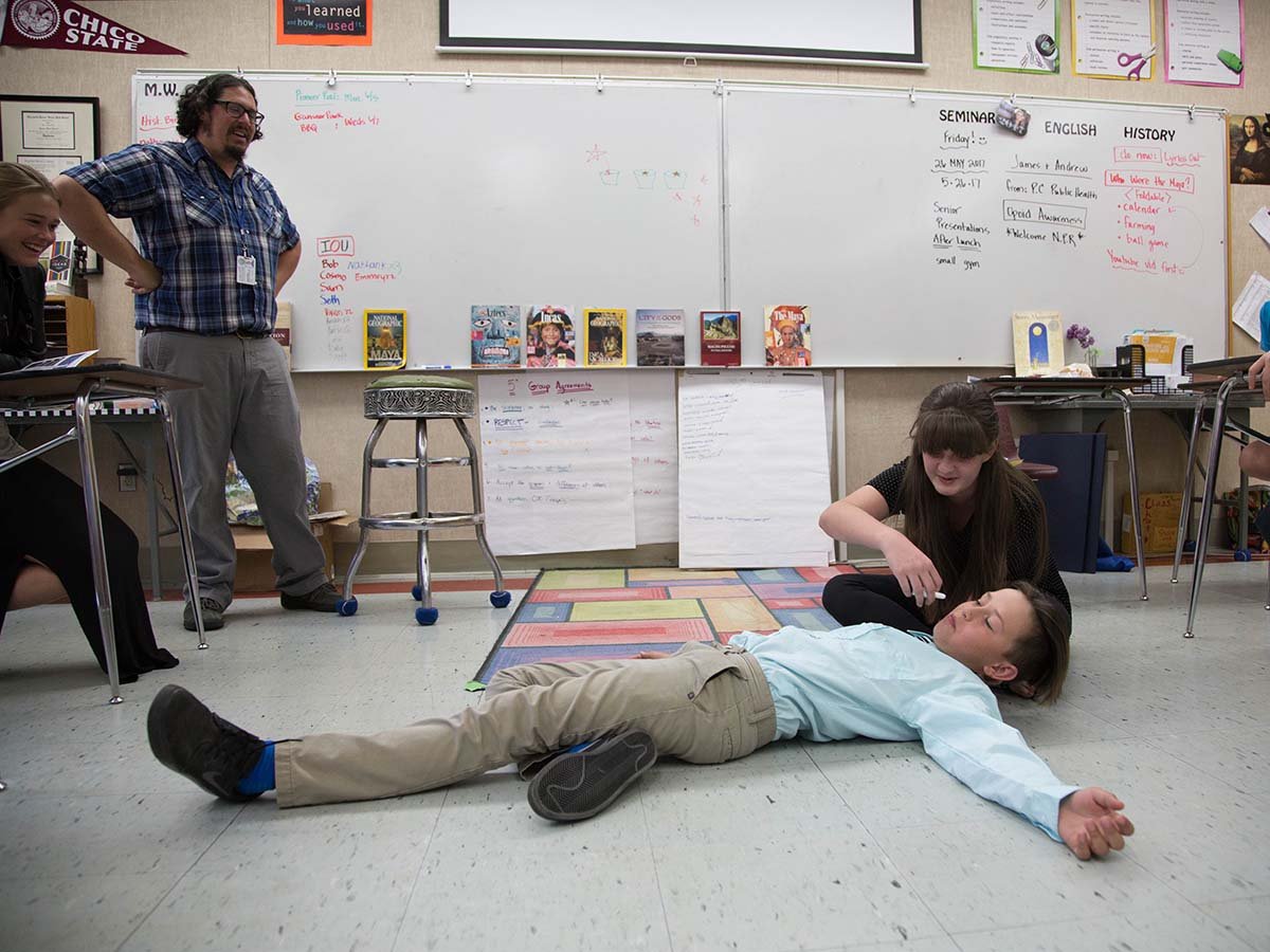 James Wilson looks on as 7th grade students at Quincy Junior and Senior High learn to administer the overdose reversal drug naloxone.