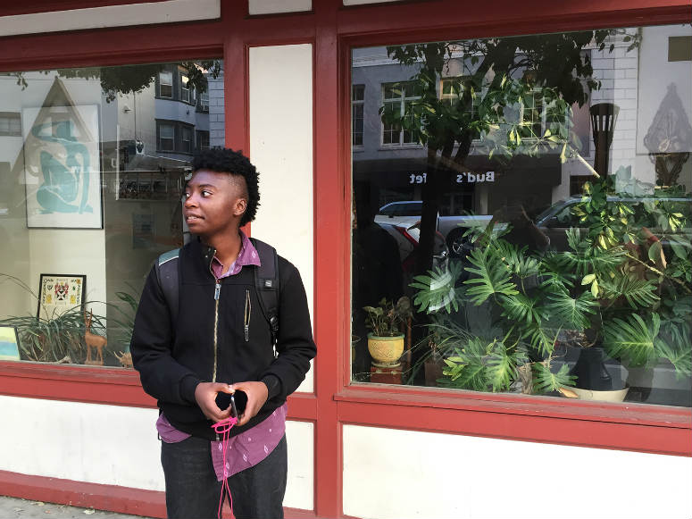 Eroz Burse stands outside his apartment building in a busy area in downtown Sacramento.