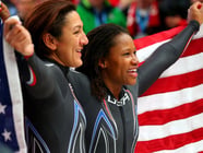 U.S. silver medalists Elana Meyers, left, and Lauryn Williams pose after their final run in the women's bobsled Wednesday. Williams becomes only the second American in history to win medals in both the Summer and Winter Olympics.
