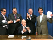 Calif. Gov. Jerry Brown signs the 2013-14 state budget, as Democratic legislative leaders and Budget Committee chairs watch.