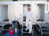 Mark Lytal poses by the showers he manages for unhoused people in downtown Sacramento on Friday, April 10, 2020.
