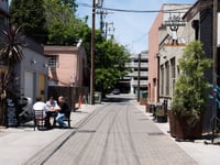 Patrons sit across the alley, far from the entrance to Old Soul in Liestal Alley, one of the cafes and restaurants serving dine-in customers in Sacramento County Friday, May 22, 2020.
