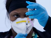 Licensed vocational nurse Jelisa Stewart prepares a dose of the Moderna COVID-19 vaccine for farmworkers at a County of Santa Clara mobile vaccination clinic at Monterey Mushrooms in Morgan Hill, Calif., Wednesday, March 3, 2021.