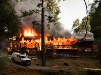 A home in the community of Chicago Park near Colfax is engulfed in flames on Mount Olive Road during the River Fire on Wednesday, Aug. 4, 2021.