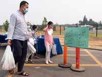 Abdul Azizi and his children attend a food distribution and resource fair at Encina High School Thursday, Aug. 19, 2021.