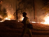 Firefighters protect homes in Christmas Valley from the Caldor Fire Monday, Aug. 30, 2021.