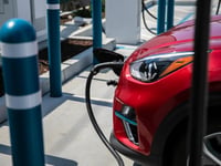 An electric vehicle charges at a station in Millbrae.