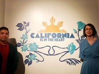 California Museum archivist Jason Sarmiento and executive director Amanda Meeker pose in front of an entrance to the California is in the Heart exhibit, which highlights Filipino contributions to state history. The exhibit opens on Oct. 29, 2022.