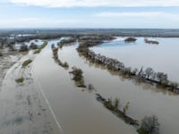 A drone view shows Fremont Weir along the Sacramento River overtopping in Knights Landing, Calif. on Monday, January 9, 2023.