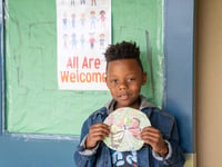 Cardiair Potts, 7, shares the art project for the week at Glenwood Elementary School in Sacramento, which celebrates the arrival of spring.