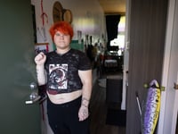 Caesar LaVey stands at the entrance to his micro apartment in Sacramento, Calif., Thursday, Aug. 24, 2023.