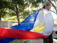 Kirby Araullo holds the flag of the Philippines in Elk Grove on Friday, May 20, 2022.