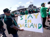 Reuben Ortiz of Modesto, Calif., holds a sign outside Oakland Coliseum to protest the Oakland Athletics' planned move to Las Vegas before the A's game with the Tampa Bay Rays on June 13, 2023.
