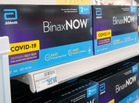 Boxes of BinaxNow home COVID-19 tests made by Abbott are shown for sale Monday, Nov. 15, 2021, at a CVS store in Lakewood, Wash., south of Seattle.