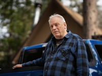 Bill King stands outside his home in Arrowbear Lake, a community near Running Springs, on Jan. 15, 2024.