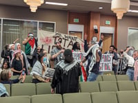 A group of people protesting at the Tuesday, March 19, 2024 Sacramento City Council meeting. Council members were on a recess from hearing public comment on a proposed resolution calling for a cease-fire in Gaza.