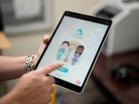 An employee of Hazel Health displays the opening page of the company's app, which allows Miami-Dade County public school students to receive telehealth therapy services, on World Mental Health Day, Tuesday, Oct. 10, 2023 in Miami.