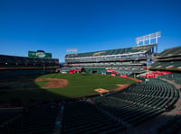 Fans walk to their seats before the start of a baseball game, April 2, 2024, in Oakland, Calif.