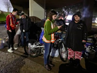 (From left) Volunteers Johnny Wong and Sarah Danon interview Alicia Garcia and Robert Penn, who both live under the Howe Avenue bridge, during the Point-in-Time count of people experiencing homelessness in Sacramento Jan. 24, 2024.