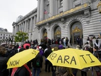 A crowd listens to speakers at a reparations rally outside of City Hall in San Francisco, on March 14, 2023.