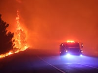 Firefighters drive through an active portion of the Park Fire in Butte County on July 26, 2024.