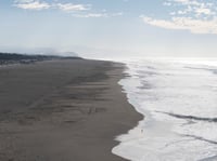 People walk along the sand at Ocean Beach in San Francisco during a tsunami warning on Thursday, Dec. 5, 2024.