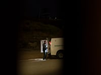 A Border Patrol agent loads migrants seeking asylum into a van to be processed, Tuesday, June 4, 2024, in San Diego.