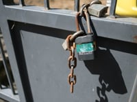 A lock and chain on the gate that separates the Marina Vista housing project from the much wealthier Land Park neighborhood.