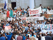 Hundreds of protesters gather at Los Angeles City Hall, Nov. 7, 1994, demonstrating against the so-called "Save Our State" proposition, Prop 187.