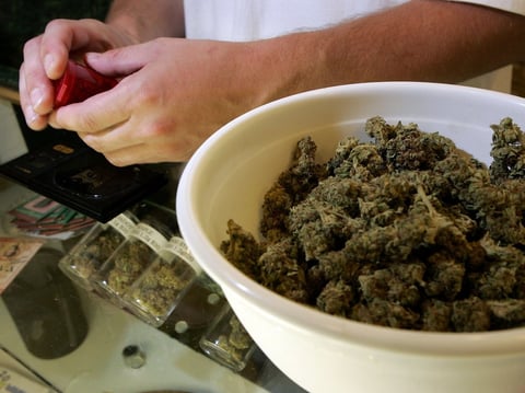 A worker packages medical marijuana in San Francisco in 2006. City prosecutors say they'll clear thousands of marijuana convictions.
