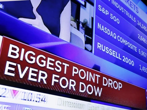 A television screen on the floor of the New York Stock Exchange headlines the stock index news at the close of trading, Monday, Feb. 5, 2018.