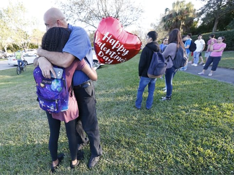 Family member embrace following a shooting at Marjory Stoneman Douglas High School, Wednesday, Feb. 14, 2018, in Parkland, Fla. 