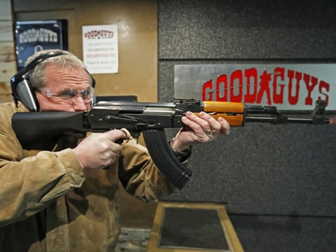 Vince Warner fires an AK-47 with a bump stock installed at Good Guys Gun and Range in Utah. A significant majority of Americans favor outlawing the attachment, according to the latest NPR/Ipsos poll.

